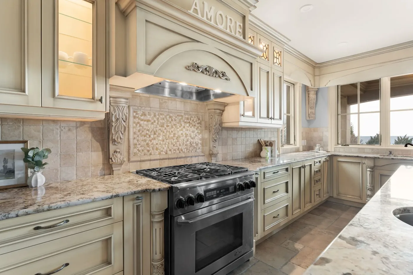 A traditional kitchen with a carved range hood